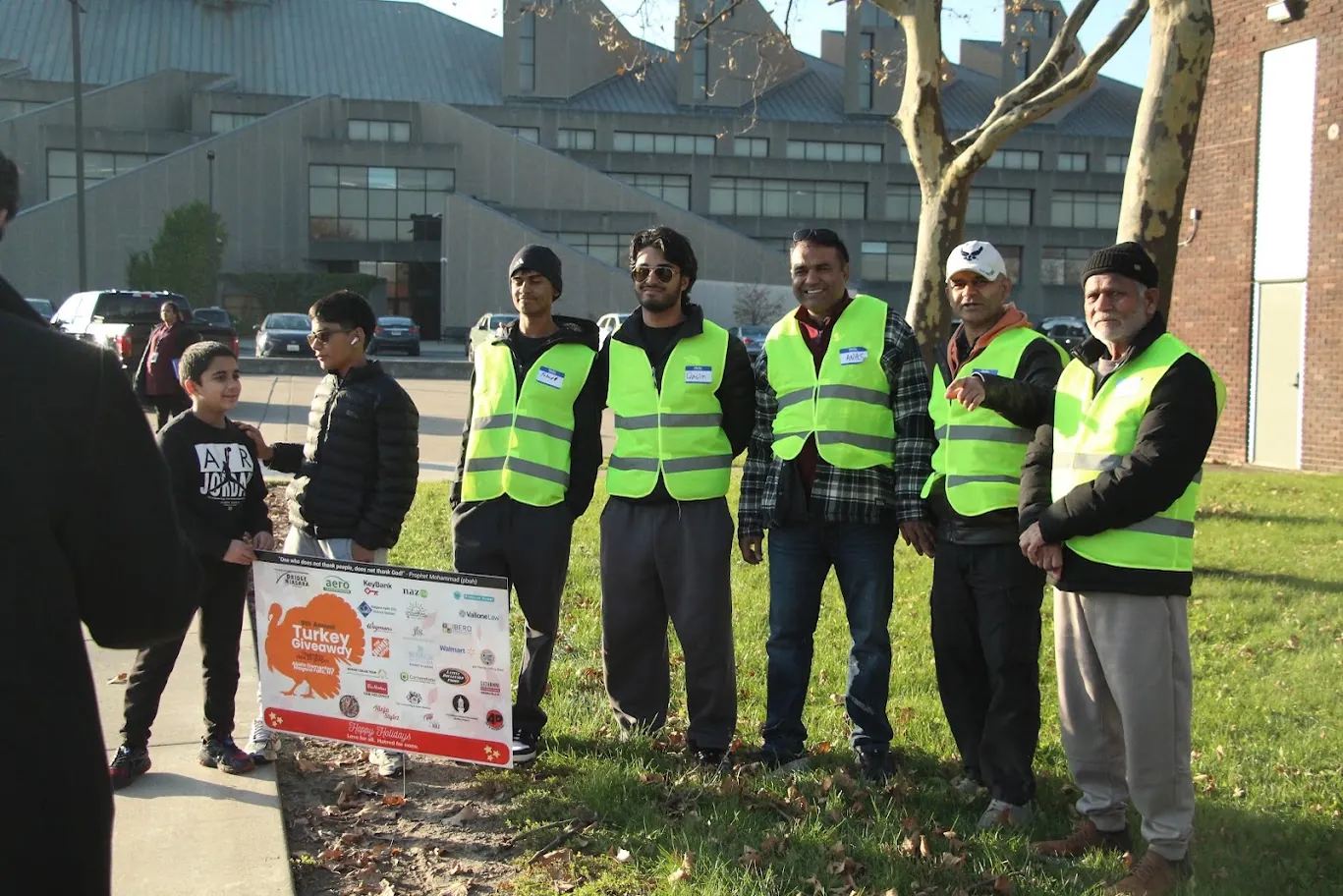 Volunteers wearing high-visibility vests assemble before a past Turkey Giveaway